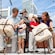 Mom, dad and the kids help a colonist toss bundles of tea overboard